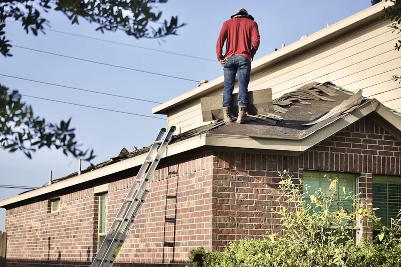 Professional roofer working on a residential roof in Hiddencreek